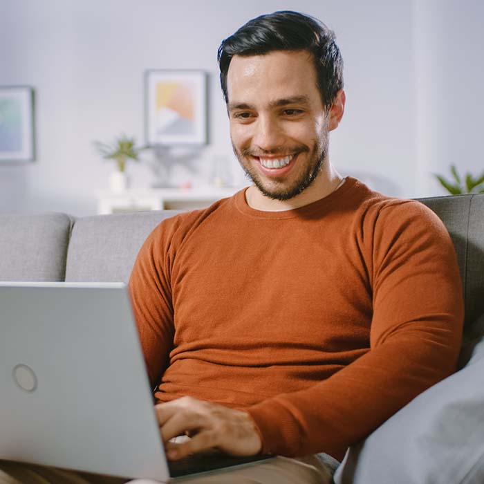 happy entrepreneur working on a laptop