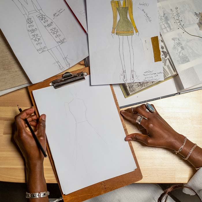 a fashion designer drawing concepts