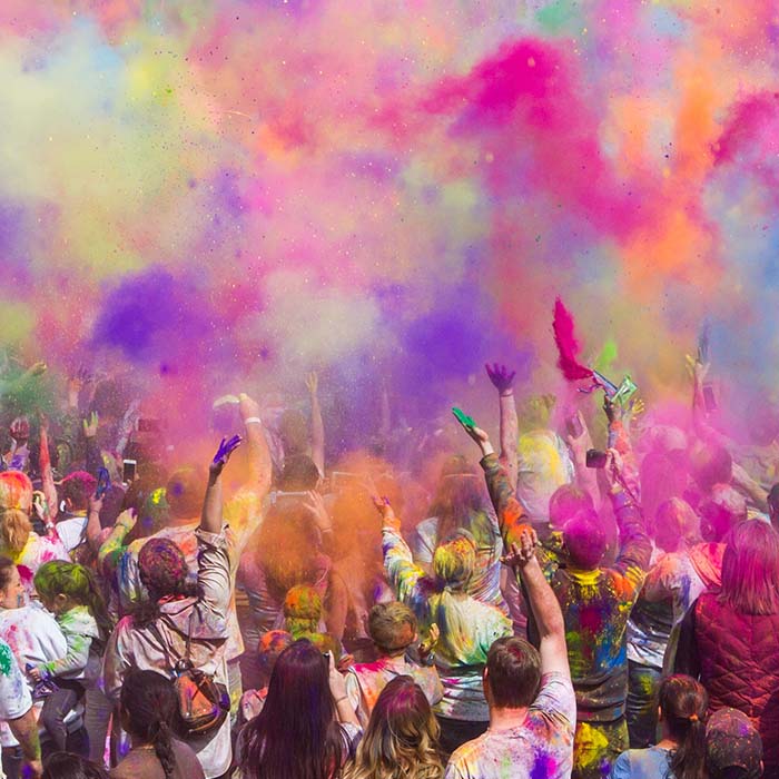people throwing coloured powder into the air