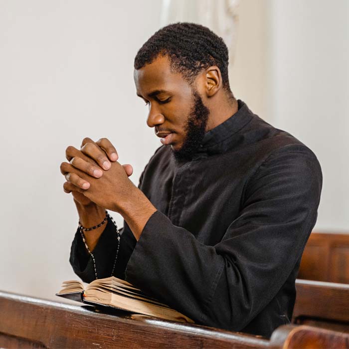 a young priest praying
