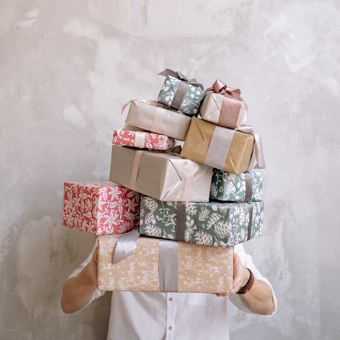 a person holding a bunch of gifts