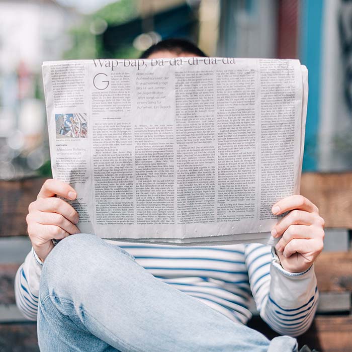 a person reading the newspaper